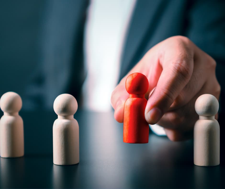 Imagem de uma mão segurando uma peça vermelha entre várias peças brancas, simbolizando individualidade e tomada de decisão. No site Vam'Bora,Meu!.com.br, promovemos motivação e autoajuda, abordando autoestima, autoconhecimento, desenvolvimento pessoal, coaching e meditação para melhorar a qualidade de vida.